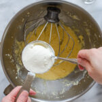 Adding the sour cream to the batter.