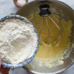 Adding the flour mixture to the batter.