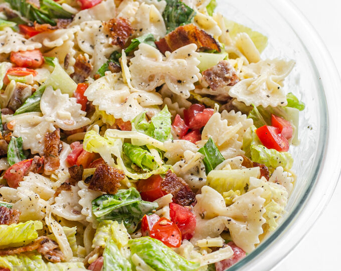 A large bowl of BLT bowtie pasta salad.