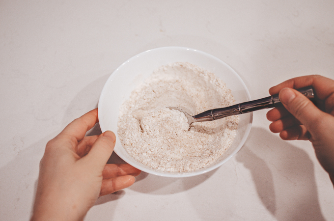 Mixing together a 50/50 blend of whole wheat and all purpose flour to feed my sourdough starter. 