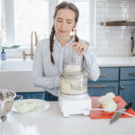 Shredding sauerkraut with a food processor.