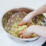 Massaging cabbage to make spicy sauerkraut.