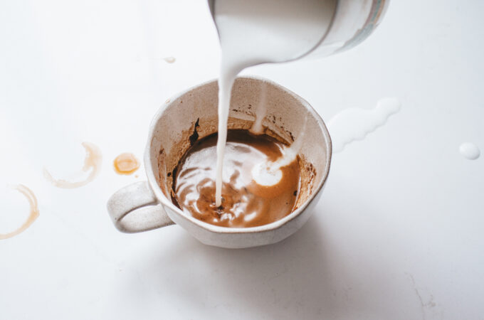 Pouring frothed milk into a cafe mocha.