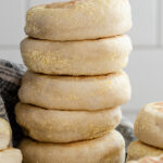 A stack of fresh Sourdough English Muffins.