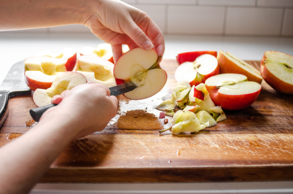 Coring the apples with a pairing knife. 