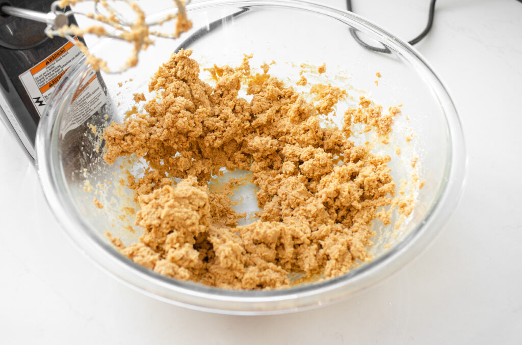 Mixing together the peanut butter, butter, and powdered sugar.