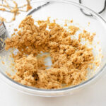 Mixing together the peanut butter, butter, and powdered sugar.