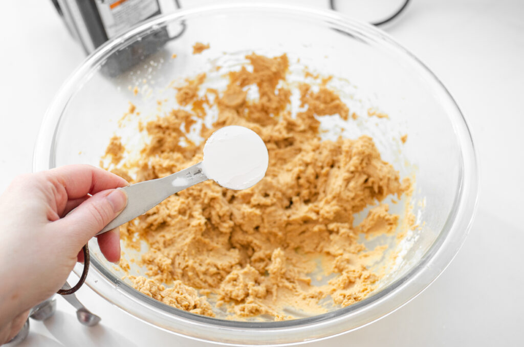 Adding extra powdered sugar to the dough to get the right consistency. 