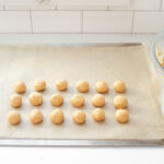 Rolling out the balls of peanut butter dough to make buckeyes without shortening.