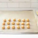 Rolling out the balls of peanut butter dough to make buckeyes without shortening.