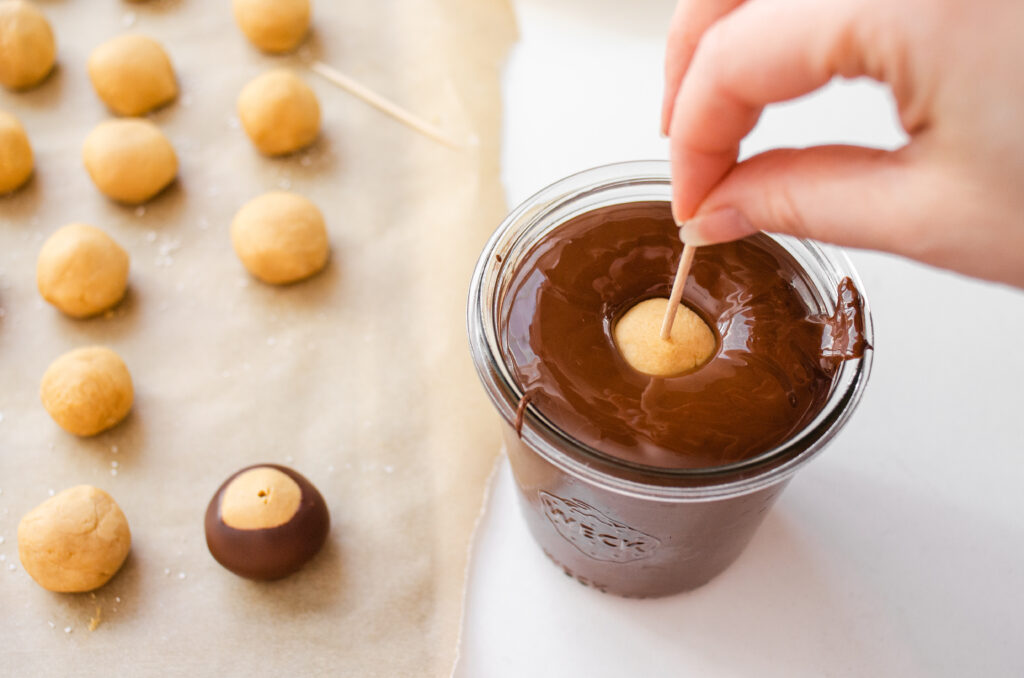 Dipping the peanut butter buckeye into the chocolate without shortening. 