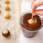 Dipping the peanut butter buckeye into the chocolate without shortening.