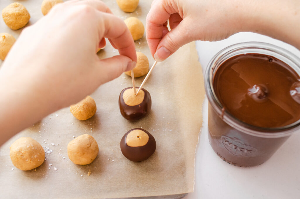 Placing the buckeyes back on the baking sheet. 