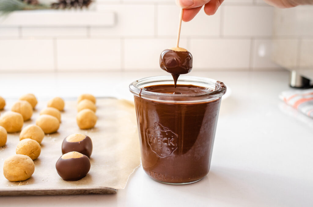 Letting the chocolate drip back into the glass. 