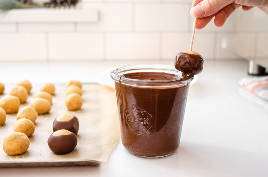 Wiping some of the chocolate off on the side of the glass.