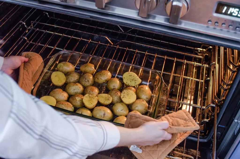 Placing the potatoes in the oven to par bake. 