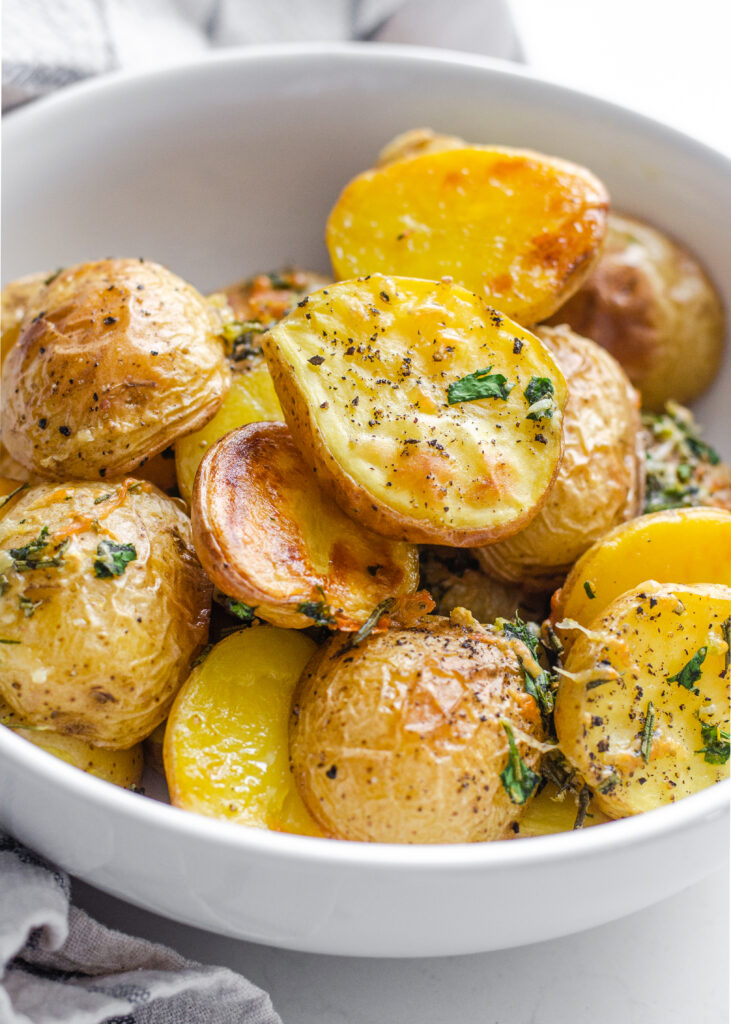 Elevated Roasted Little Potato recipe with fresh herbs, lemon, garlic, and parmesan cheese.