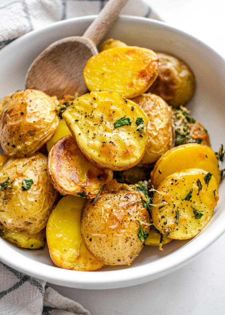 Elevated Roasted Little Potato recipe with fresh herbs, lemon, garlic, and parmesan cheese.