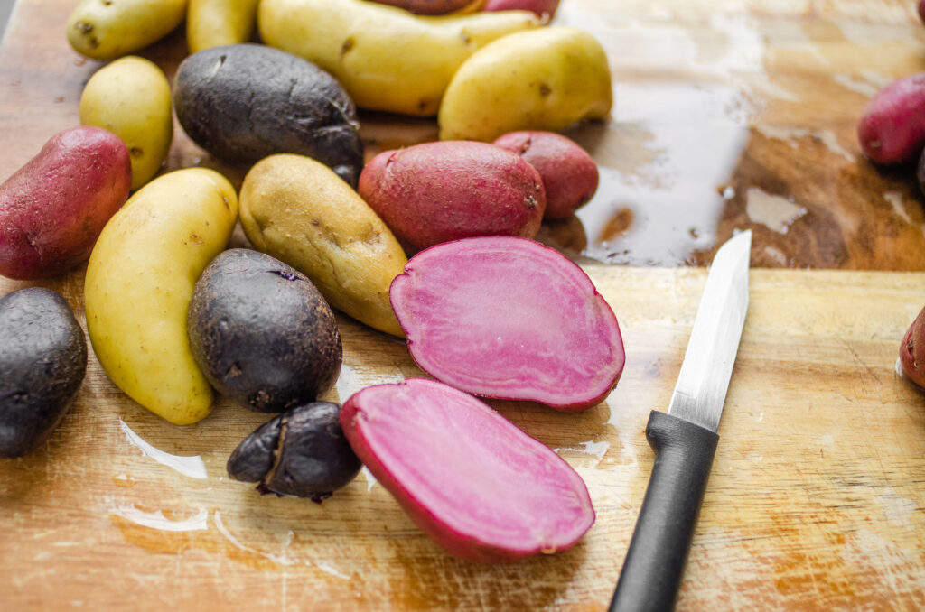 Slicing the larger fingerling potatoes in half. 