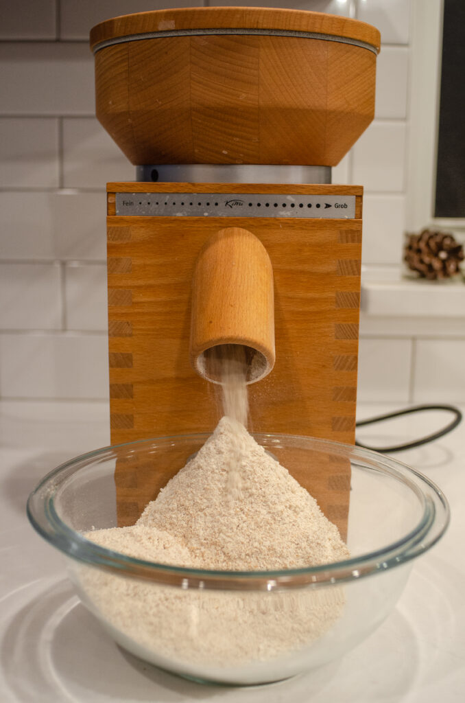 Grinding wheat berries into freshly milled whole wheat flour using th e KoMo Fidibus classic.