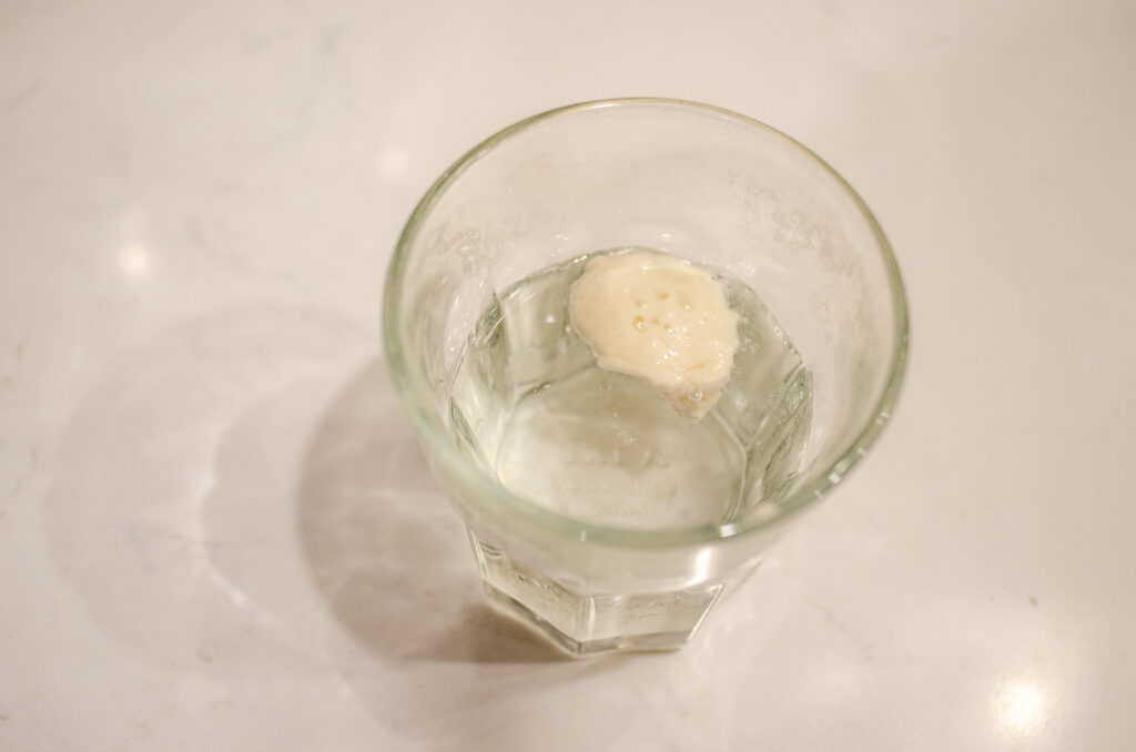 Performing the float test on a sourdough starter.