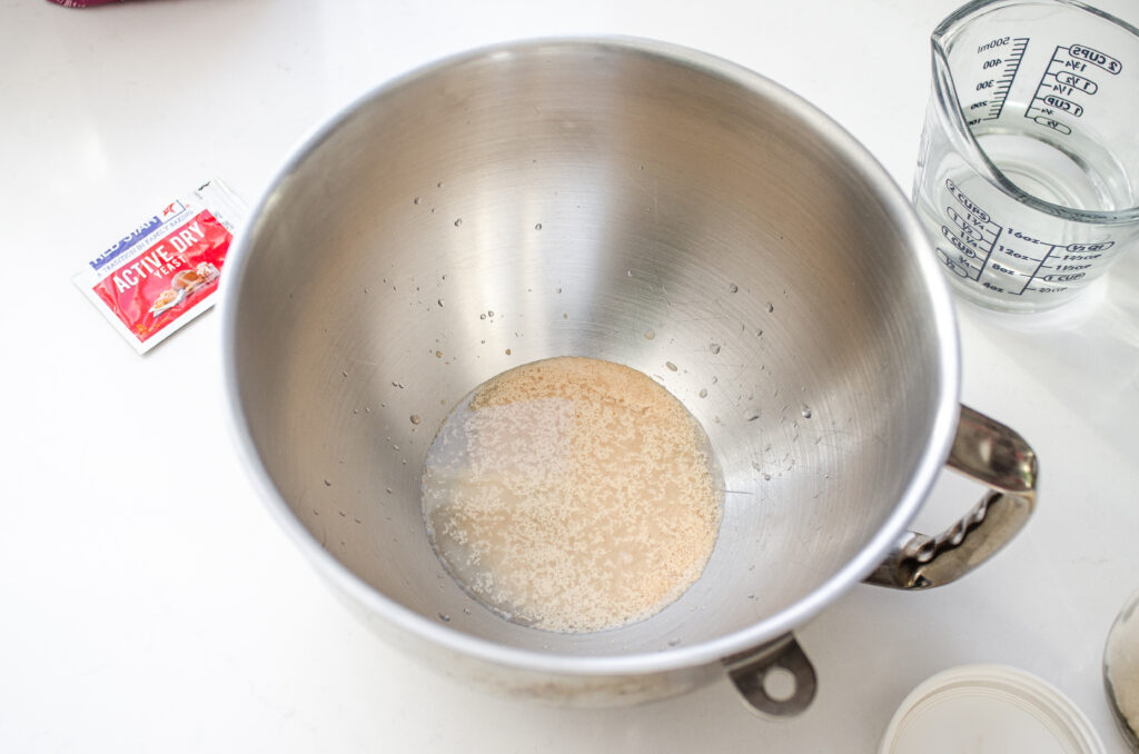 Activating the instant dry yeast in the bowl of a stand mixer.