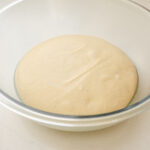 The risen dough in a greased bowl.