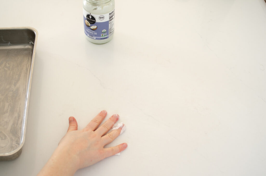 Greasing a counter with coconut oil. 