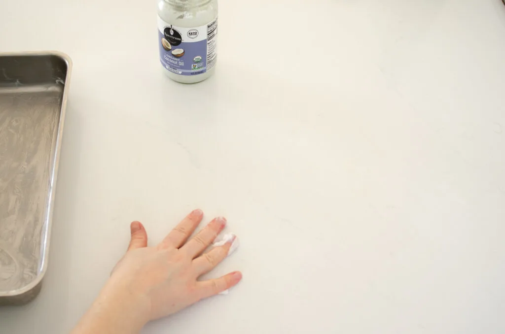 Greasing a counter with coconut oil. 
