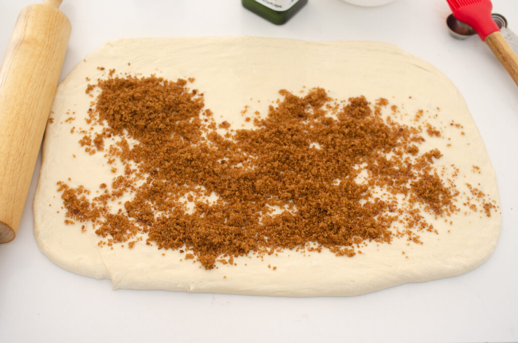 Sprinkling the dough with the cinnamon sugar mixture. 