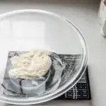 Placing the water and sourdough starter in a large mixing bowl.