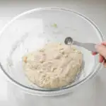 Adding the salt to the sourdough pizza dough.