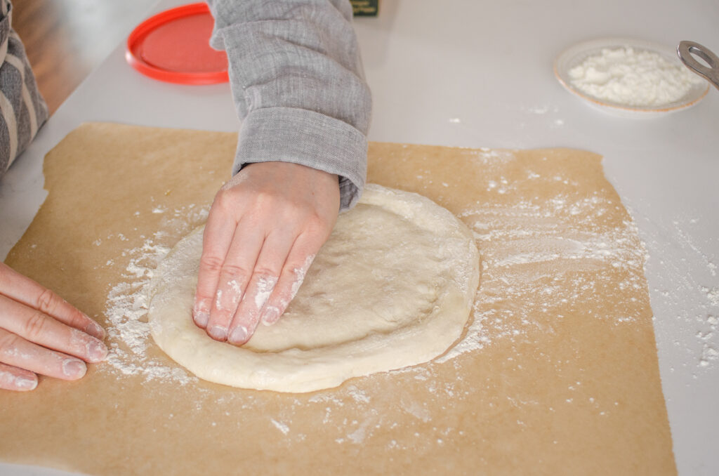 Stamping the edge of the dough.