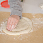 Stamping the edge of the dough.