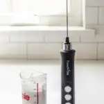 Whipping cream with a hand held milk frother.