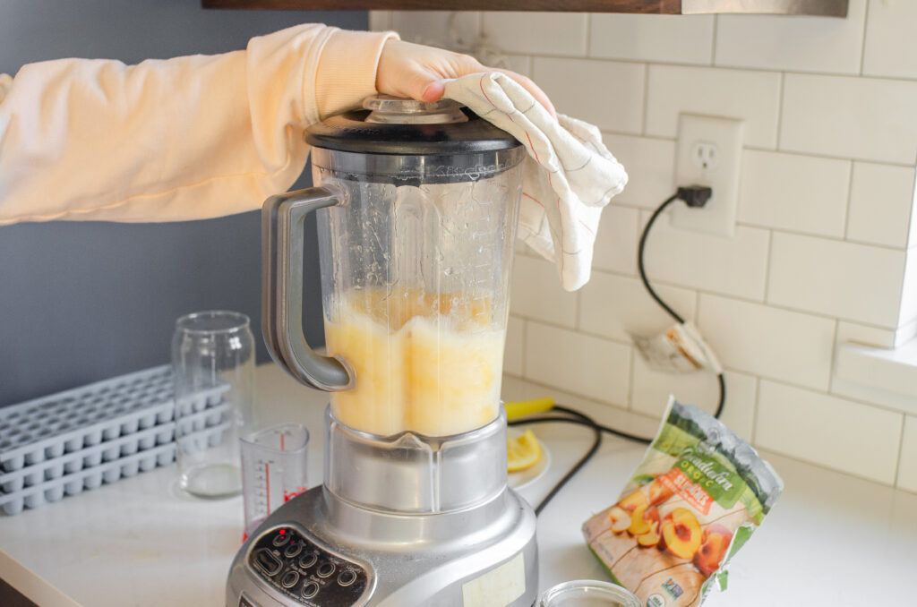 Blending together the Starbucks Peach Green Tea Lemonade until smooth.