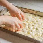 Dimpling the sourdough focaccia dough.