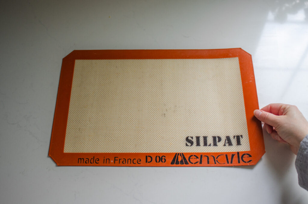 A silpat pad on a white countertop.