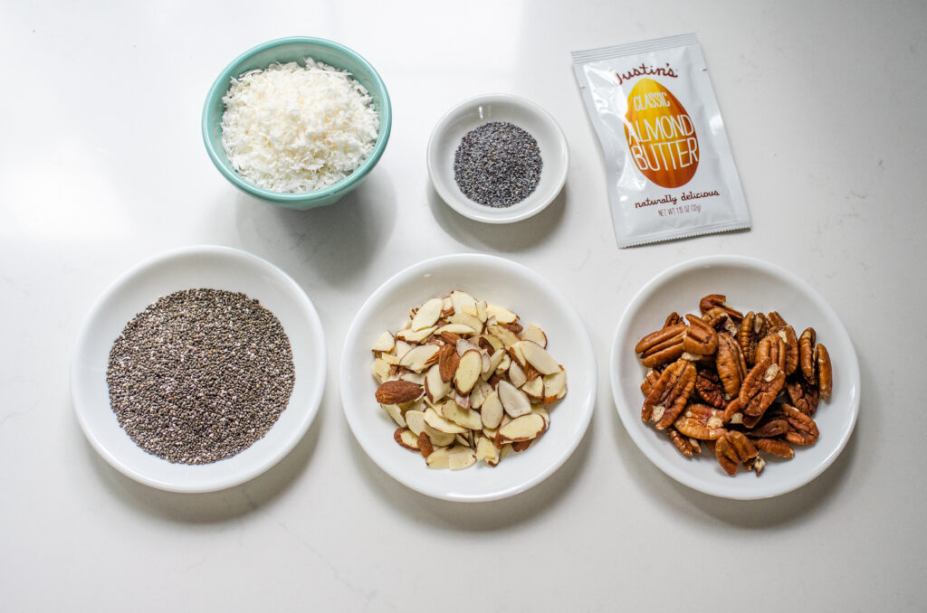 Topping ideas for blueberry oatmeal: chia seeds, shredded coconut, poppy seeds, sliced almonds, crunchy pecans, and almond butter.