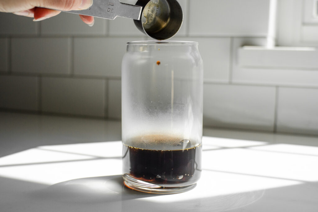 Adding the brown sugar simple syrup on top of the boba.