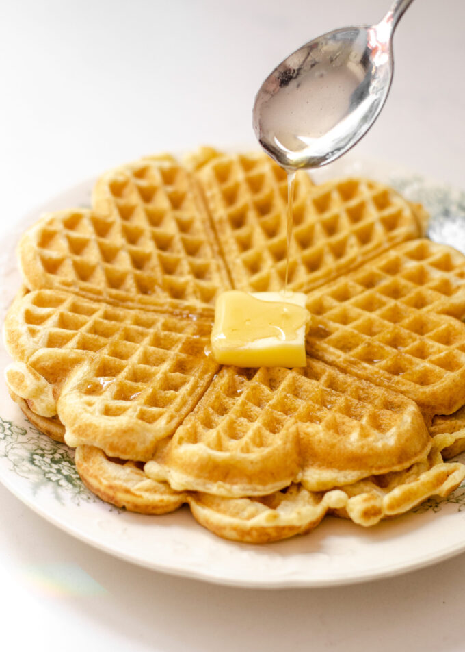 Drizzling maple syrup on a sourdough discard waffle.