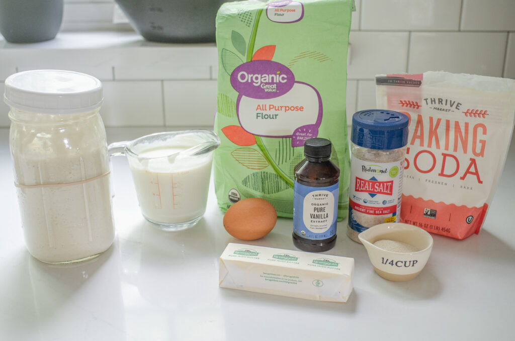 All of the ingredients needed to make my sourdough discard waffles recipe laid out on a white countertop.