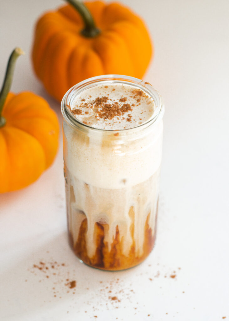A glass of pumpkin cold foam with pumpkin pie seasoning sprinkled on top.