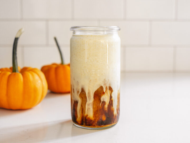 A glass of pumpkin cream cold brew with pumpkin cold foam.