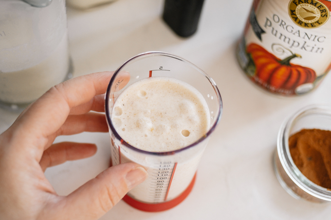 Making the pumpkin cold foam in a small measuring cup.