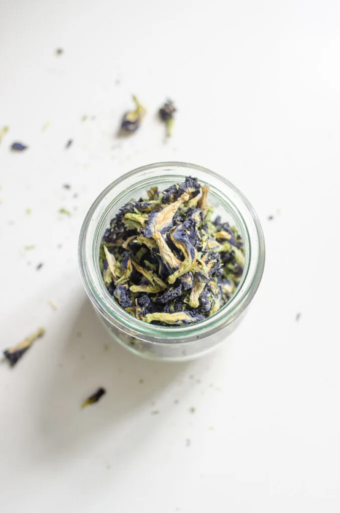 A jar of dried blue butterfly pea flowers.