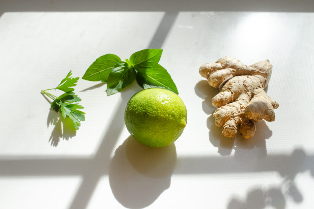 Fresh herbs and fruit laid out on a counter for ideas for variations of flavors for cucumber lemon mint water.