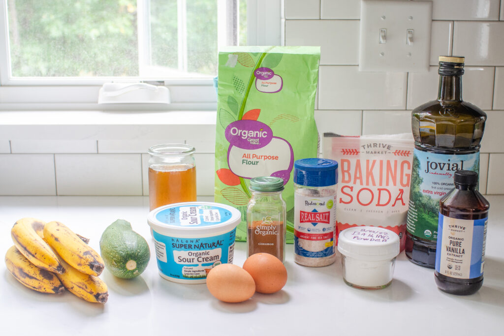 All of the ingredients needed to make banana zucchini bread at home. 