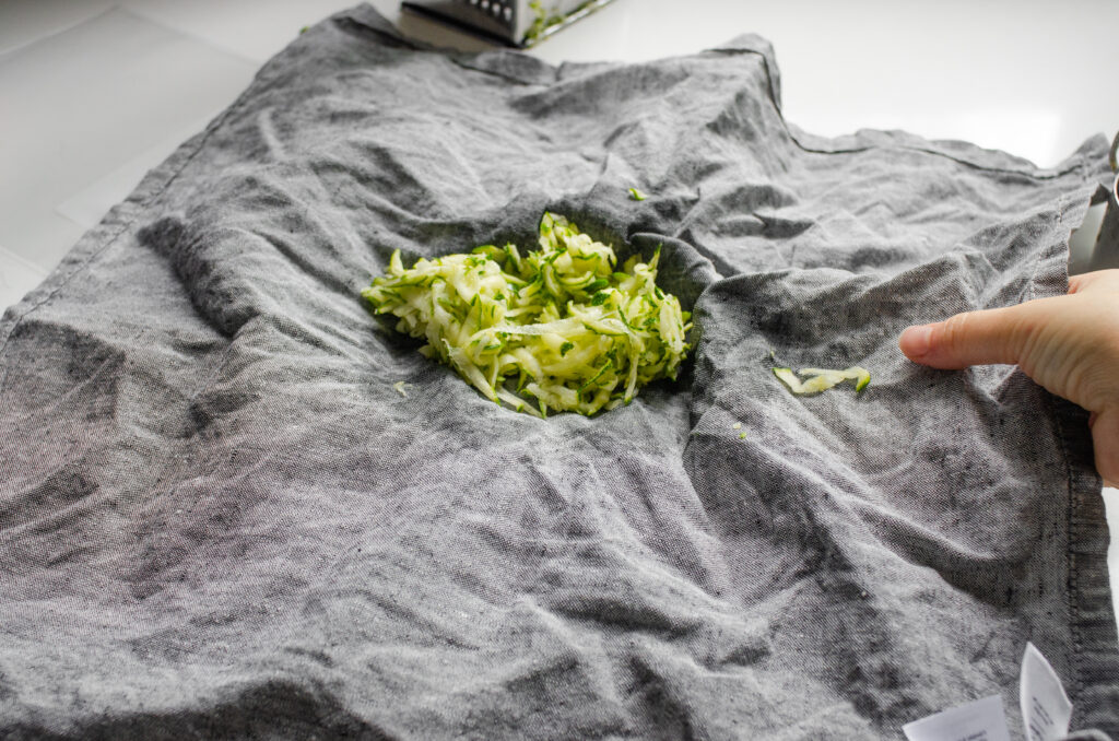 Squeezing out shredded zucchini.