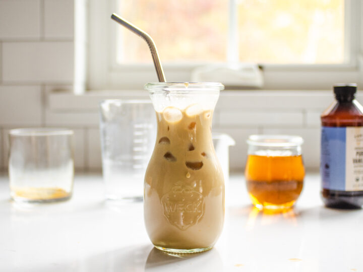A homemade Starbucks bottled Frappuccino on a countertop with the ingredients behind it.